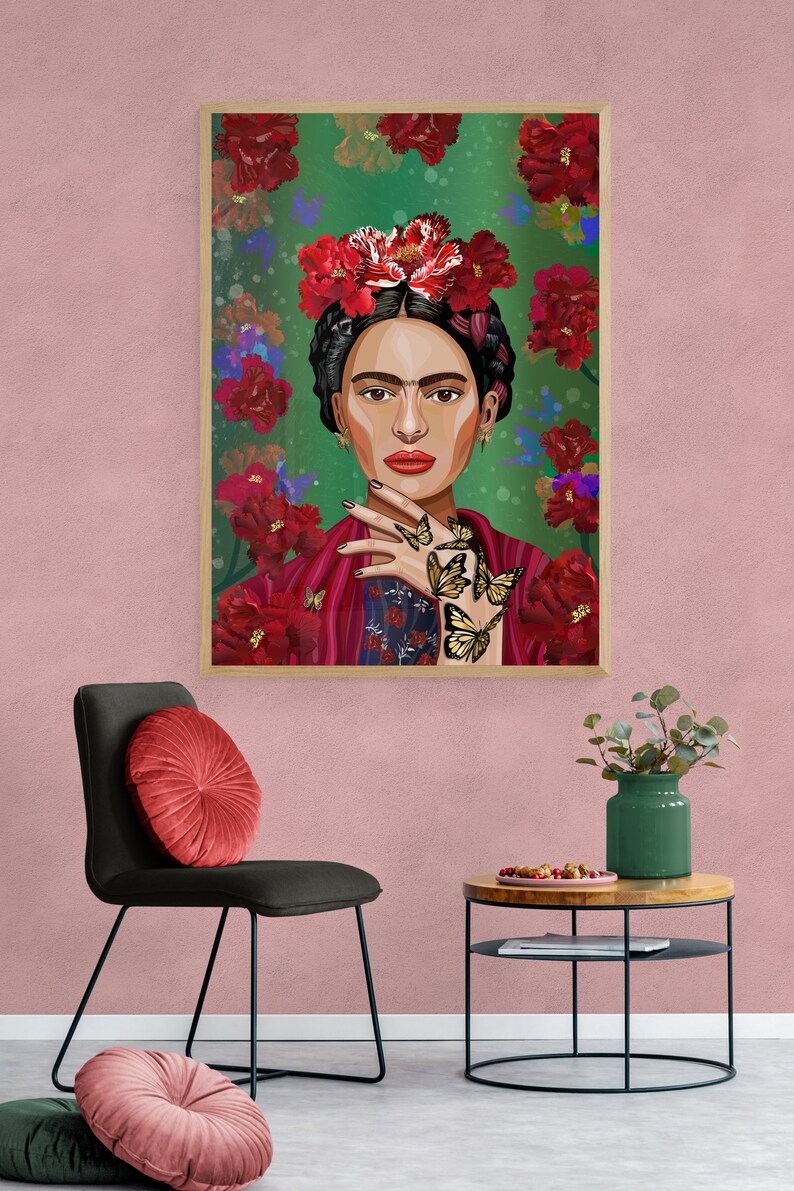 May include: A framed illustration of a woman with dark hair and a flower crown. She is wearing a red and blue patterned shawl and has butterflies on her hand. The background is green with red flowers.