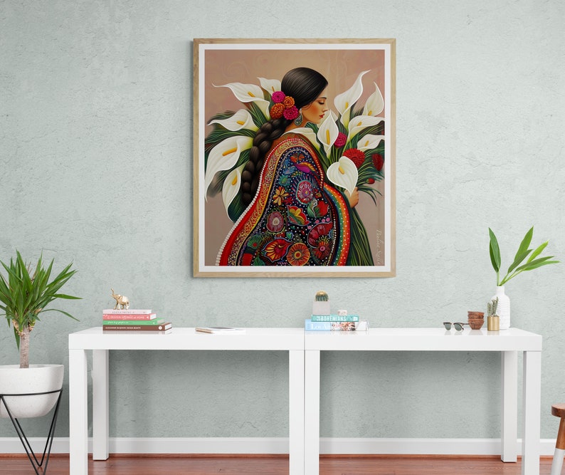 May include: A painting of a woman in a colourful embroidered dress holding a bouquet of white calla lilies.
