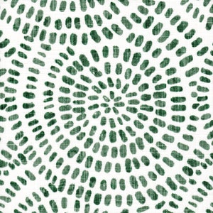 May include: White fabric with a repeating pattern of dark green, oval-shaped brushstrokes arranged in a radial design. The brushstrokes have a textured appearance, creating a visually interesting surface.