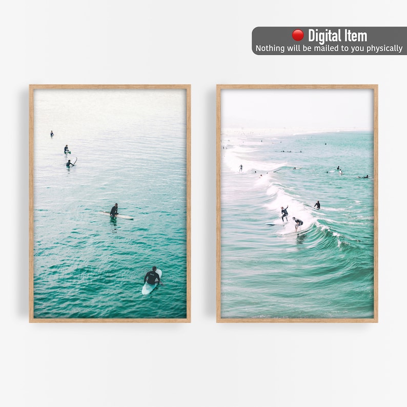May include: Two framed prints featuring ocean scenes. One shows surfers in the water, riding waves. The other shows people on surfboards in the ocean. The water is a teal color, and the frames are light brown. The text "Digital Item" is at the top.