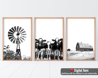 May include: A set of three black and white printable wall art prints featuring a windmill, a group of cows, and a barn. The prints are framed in a light wood frame.