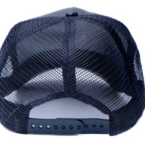May include: Black mesh trucker hat with a black adjustable strap in the back.