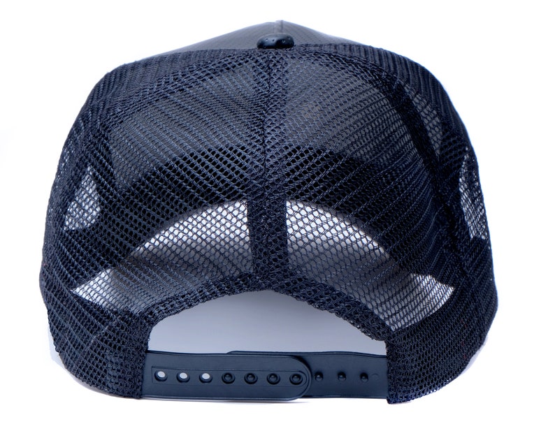 May include: Black mesh trucker hat with a black adjustable strap in the back.