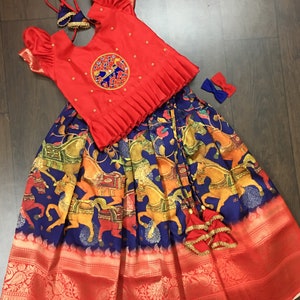 custom made kalamkari pattu pavadai with kanchi border paired with beautiful maggam work blouse.