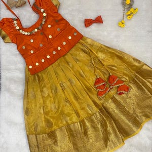 Custom made golden lehenga paired with beautiful kasu work blouse.