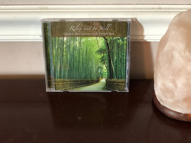 May include: A CD case with a green bamboo forest image and the text "Relax and be Still Guided Meditations with Joseph  Leo"