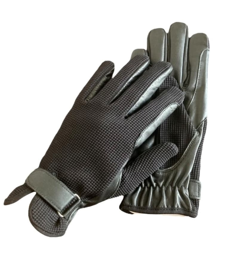 May include: A pair of black leather riding gloves with a textured grip and a strap on the wrist.