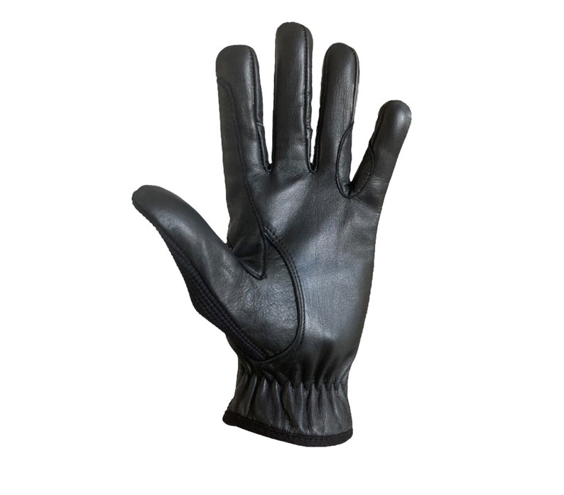May include: Black leather driving gloves with a textured palm and a black elastic wrist band.