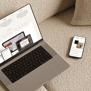 May include: A silver laptop with a black keyboard displays a presentation titled "COURSE NAME" with multiple screens. A smartphone next to the laptop shows a webpage with the text "Forbes" and "Vogue". The devices are on a beige textured surface.