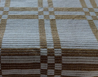 May include: A white tablecloth with a brown checkered pattern. The tablecloth is woven with a fine texture and has a subtle sheen.