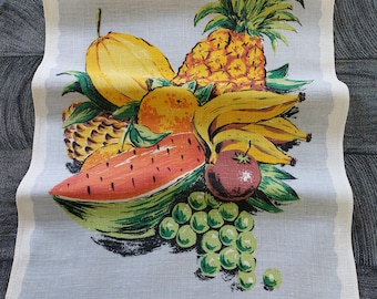 May include: A vintage kitchen tea towel with a colorful illustration of a variety of fruits, including a pineapple, bananas, watermelon, grapes, and oranges. The text "100% LINEN" and "FAST COLOURS" is printed at the bottom of the towel.