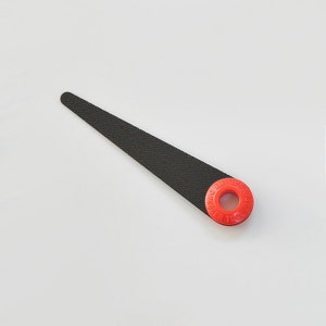 May include: A black metal file with a red plastic handle. The handle has the text "PERFECT TOOL" printed on it.