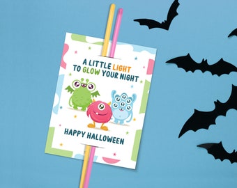 May include: A Halloween-themed card with three cartoon monsters and the text "A LITTLE LIGHT TO GLOW YOUR NIGHT" and "HAPPY HALLOWEEN". Two straws are inserted into the card. Black bat cutouts are scattered on a blue background.