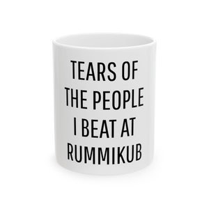 May include: White ceramic mug with black text that reads "Tears of the people I beat at Rummikub".