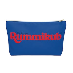 May include: A royal blue zippered pouch with a white zipper and the red text "The Original Rummikub" printed on the front.
