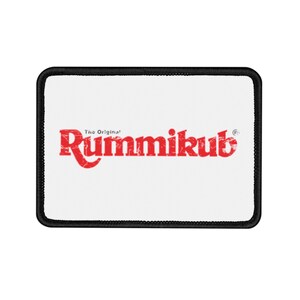 May include: White rectangular patch with a black border. The patch has the red text "The Original" above the word "Rummikub" in red.