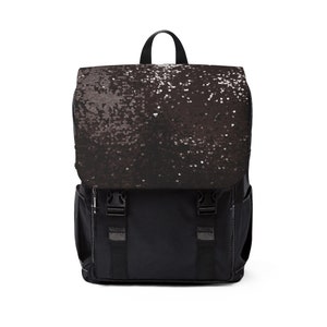 May include: Black backpack with a sequined flap. The backpack features a top handle, side pockets, and adjustable straps. The front has two black buckles and straps. The bag is suitable for everyday use.
