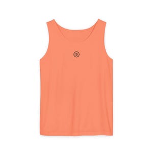 May include: A coral orange sleeveless tank top with a small black circle containing the letter "B" on the front.