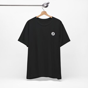 May include: A black t-shirt with a white Bitcoin logo on the left chest.