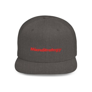 May include: A dark grey baseball cap with a flat peak. The red embroidered text "MicroStrategy" is centered on the front. The cap is made of a textured fabric.