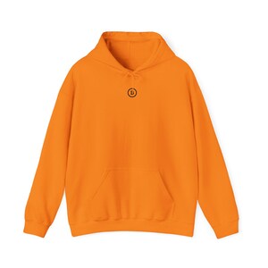 May include: Orange hoodie with a black circle and the letter "B" in the centre.
