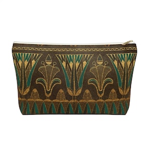 May include: A brown zippered pouch with a gold and green Egyptian-inspired pattern. The pattern features stylised lotus flowers and geometric designs.