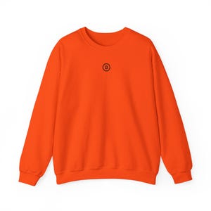 May include: Orange sweatshirt with a black circle and the letter "B" in the centre.