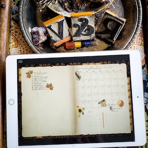 May include: A digital planner open to September 2020 with a calendar, a list titled "Mabon" with items like "harvest the night", "cleanse + white", "apples", "pumpkin", "spice", "get cozy", and "fall leaves", and a section for goals and reminders.