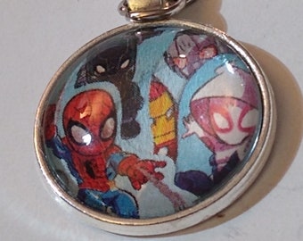 May include: A silver keychain with a round glass charm featuring a cartoon image of Spider-Man, Black Cat, and Iron Man. The charm has a blue background with white and red accents.