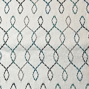 May include: White fabric with a repeating pattern of black, gray, and teal interlocking loops.