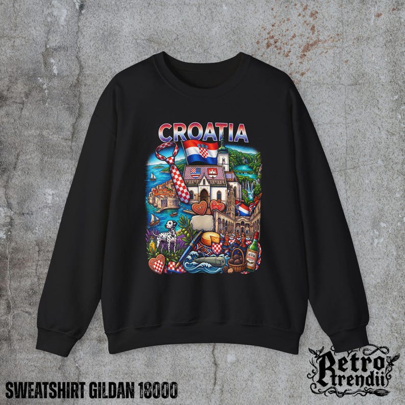 A black crewneck sweatshirt featuring a detailed graphic design of Croatia landmarks and symbols, including a Dalmatian dog, necktie, Mediterranean coast, and historic architecture, displayed on a textured grey background.