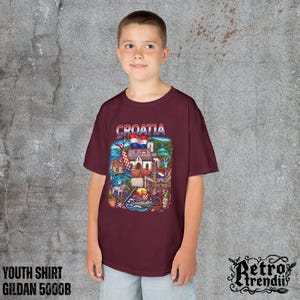 A young boy wearing a Red T-shirt featuring a colorful graphic design of Croatia landmarks and symbols, including a Dalmatian dog, necktie, Mediterranean coast, and historic architecture.