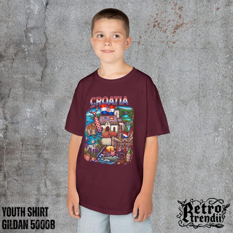 A young boy wearing a Red T-shirt featuring a colorful graphic design of Croatia landmarks and symbols, including a Dalmatian dog, necktie, Mediterranean coast, and historic architecture.