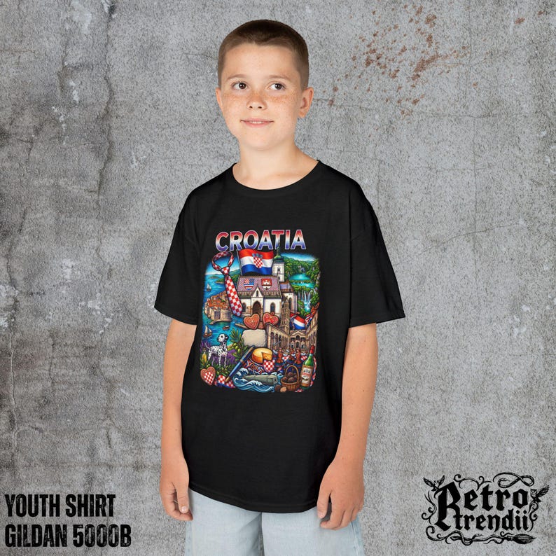 A young boy wearing a black T-shirt featuring a colorful graphic design of Croatia landmarks and symbols, including a Dalmatian dog, necktie, Mediterranean coast, and historic architecture.