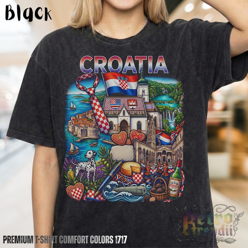 A person wearing a black acid-wash T-shirt featuring a colorful graphic design of Croatia landmarks and symbols, including a Dalmatian dog, necktie, Mediterranean coast, and historic architecture, showcasing European culture.