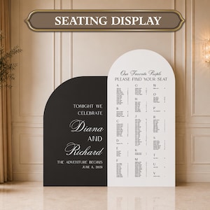 May include: A black and white arched seating display sign featuring the text "TONIGHT WE CELEBRATE Diana AND Richard THE ADVENTURE BEGINS JUNE 8, 2026" on the black panel and "Our Favorite People PLEASE FIND YOUR SEAT" with guest names on the white panel.