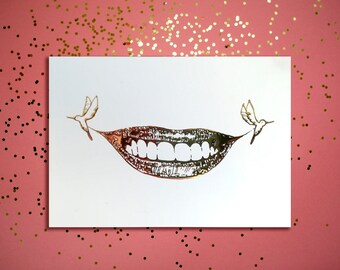 Festive and happy A6 golden greeting card illustrated with a smile with birds for the end of year celebrations or a birthday