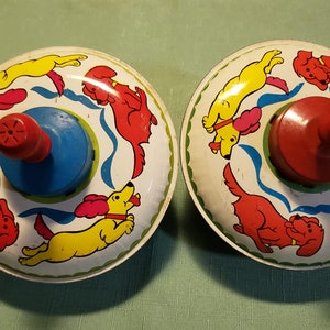 Vintage Lithograph Tin Toy Spinning Top, with yellow and red dogs, wooden finial, works, gentle used.