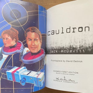 May include: A book cover with a black and white illustration of a spaceship and two people in space suits. The title of the book is "cauldron" by Jack McDevitt. The book is a signed first edition, bound in genuine leather, and published by The Easton Press.