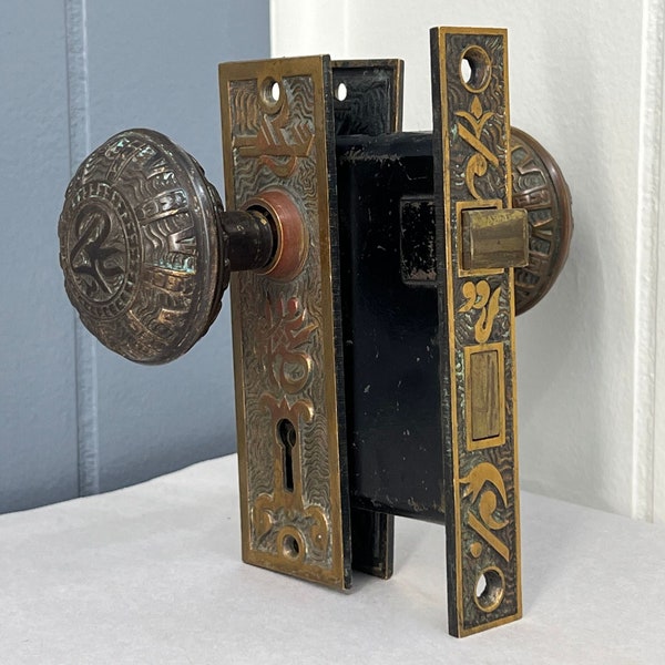 Circa 1890 Original Antique Mallory Wheeler Bronze Door Knob Hardware Set With Watered Background and "Arabic" Design