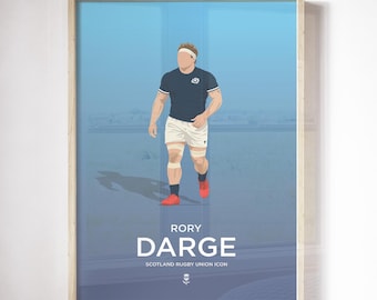 May include: A framed print featuring a stylized illustration of a rugby player in a navy blue jersey, white shorts, and red shoes. The print includes the name "RORY DARGE" and "SCOTLAND RUGBY UNION ICON" in white text against a blue background.