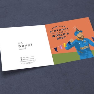 May include: A birthday card with an orange background featuring a cartoon illustration of a man wearing a blue and white jersey with the word "INDIA" on it. The man is holding a cricket bat and wearing a party hat. The text on the card reads "Hope your birthday is the world's best."