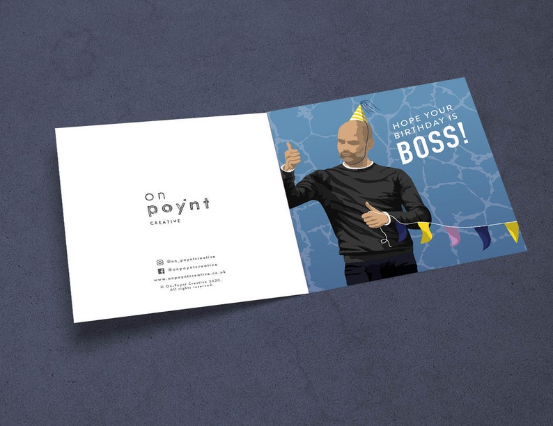May include: A birthday card featuring a cartoon illustration of a man wearing a party hat and giving a thumbs up. The card has a blue background with a white border and the text "Hope your birthday is BOSS!" in white letters.