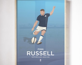 May include: A framed print featuring a stylized illustration of a rugby player kicking a ball. The player is wearing a navy blue jersey and white shorts. The print includes the name "FINN RUSSELL" and "SCOTLAND RUGBY UNION ICON".