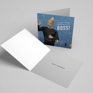 May include: A blue birthday card with a cartoon illustration of a man wearing a party hat and giving a thumbs up. The text on the card reads "Hope your birthday is BOSS!" and "Happy Birthday".