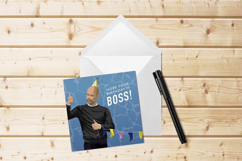 May include: A blue and white birthday card with a cartoon illustration of a man wearing a yellow party hat and giving a thumbs up. The text on the card reads "Hope your birthday is BOSS!"