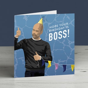 May include: A birthday card featuring a cartoon illustration of a man wearing a party hat and giving a thumbs up. The card has a blue background with a white banner that says "Hope your birthday is BOSS!"