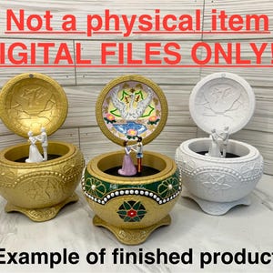 May include: Three music boxes with different designs. The top of each box is open, revealing a small figurine of a couple dancing inside. The boxes are decorated with gold, white, and green paint. The text "Not a physical item DIGITAL FILES ONLY!!" is displayed at the top of the image. The text "(Example of finished product)" is displayed at the bottom of the image.