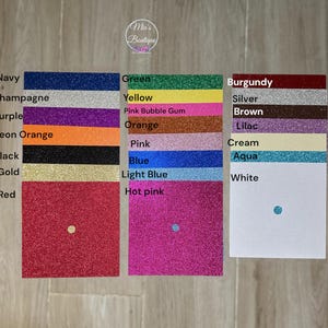 May include: A color chart with 20 different colors of glitter paper. The colors are: navy, champagne, purple, neon orange, black, gold, red, green, yellow, pink bubble gum, orange, pink, blue, light blue, hot pink, burgundy, silver, brown, lilac, cream, aqua, and white.