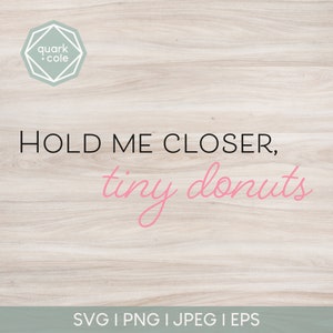 May include: A woodgrain background with the text "HOLD ME CLOSER, tiny donuts" in black and pink lettering. The text "SVG I PNG I JPEG I EPS" is at the bottom of the image.